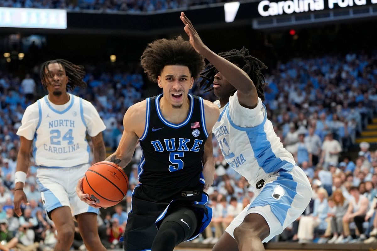 Mar 8, 2025; Chapel Hill, North Carolina, USA;  Duke Blue Devils guard Tyrese Proctor (5) with the ball as North Carolina Tar Heels guard Ian Jackson (11) defends in the first half at Dean E. Smith Center. Mandatory Credit: Bob Donnan-Imagn Images