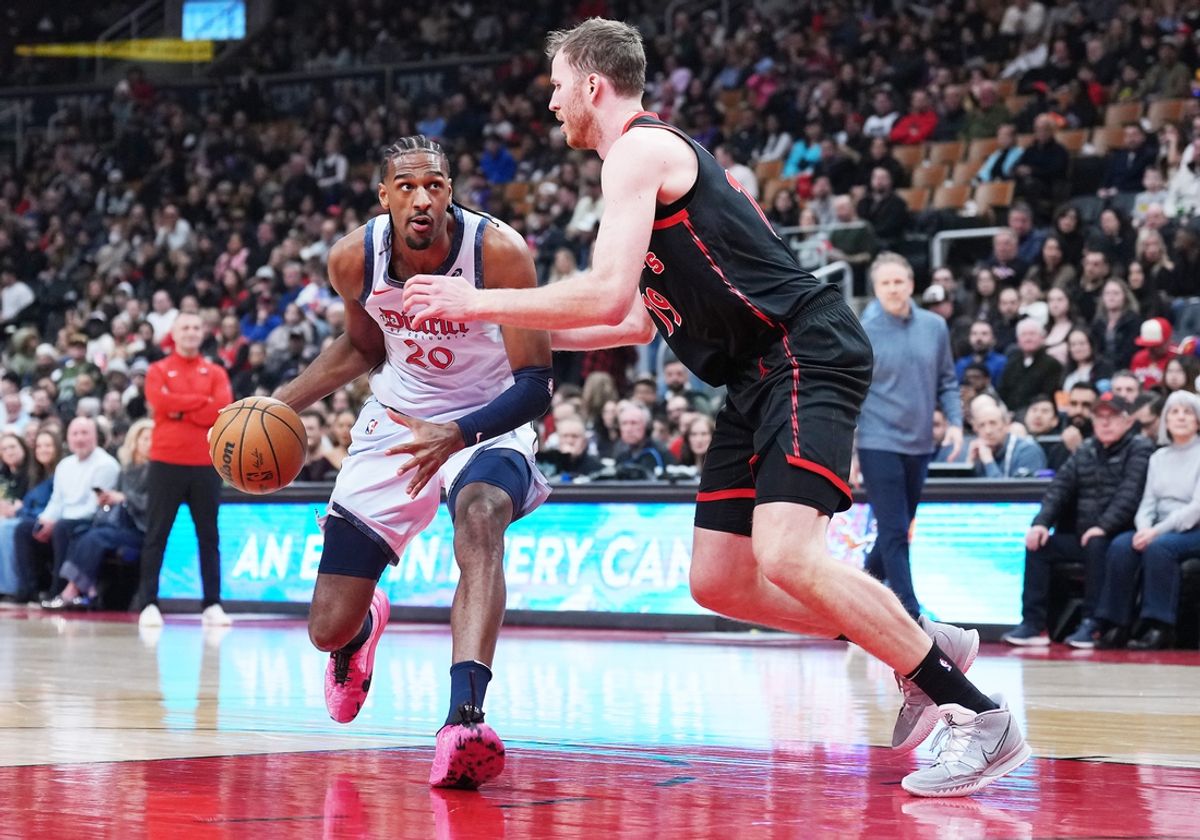 Mar 8, 2025; Toronto, Ontario, CAN;  Washington Wizards forward Alex Sarr (20) controls the ball as Toronto Raptors center Jakob Poeltl (19) tries to defend during the first quarter at Scotiabank Arena. Mandatory Credit: Nick Turchiaro-Imagn Images