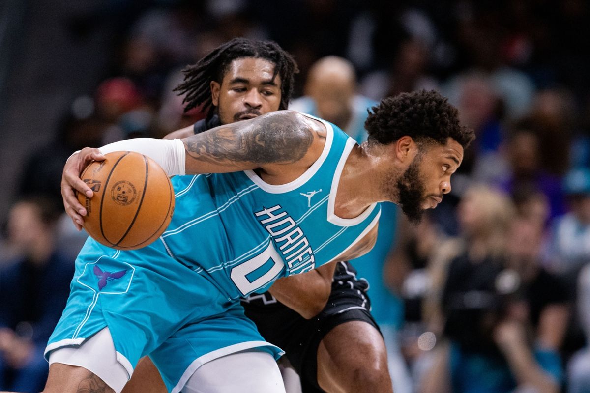 Mar 8, 2025; Charlotte, North Carolina, USA; Charlotte Hornets forward Miles Bridges (0) drives around Brooklyn Nets guard Cam Thomas (24) during the second quarter at Spectrum Center. Mandatory Credit: Scott Kinser-Imagn Images
