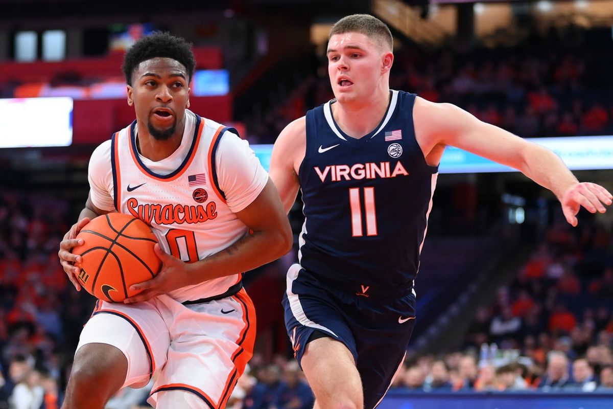 Mar 8, 2025; Syracuse, New York, USA; Syracuse Orange guard Kyle Cuffe Jr. (0) drives against Virginia Cavaliers guard Isaac McKneely (11) during the first half at the JMA Wireless Dome. Mandatory Credit: Rich Barnes-Imagn Images