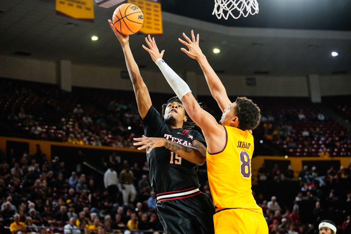 Mar 8, 2025; Tempe, Arizona, USA; Texas Tech Red Raiders forward JJ Topin (15) goes for a layup against Arizona State Sun Devils forward Basheer Jihad (8) during the first half at Desert Financial Arena. Mandatory Credit: Arianna Grainey-Imagn Images