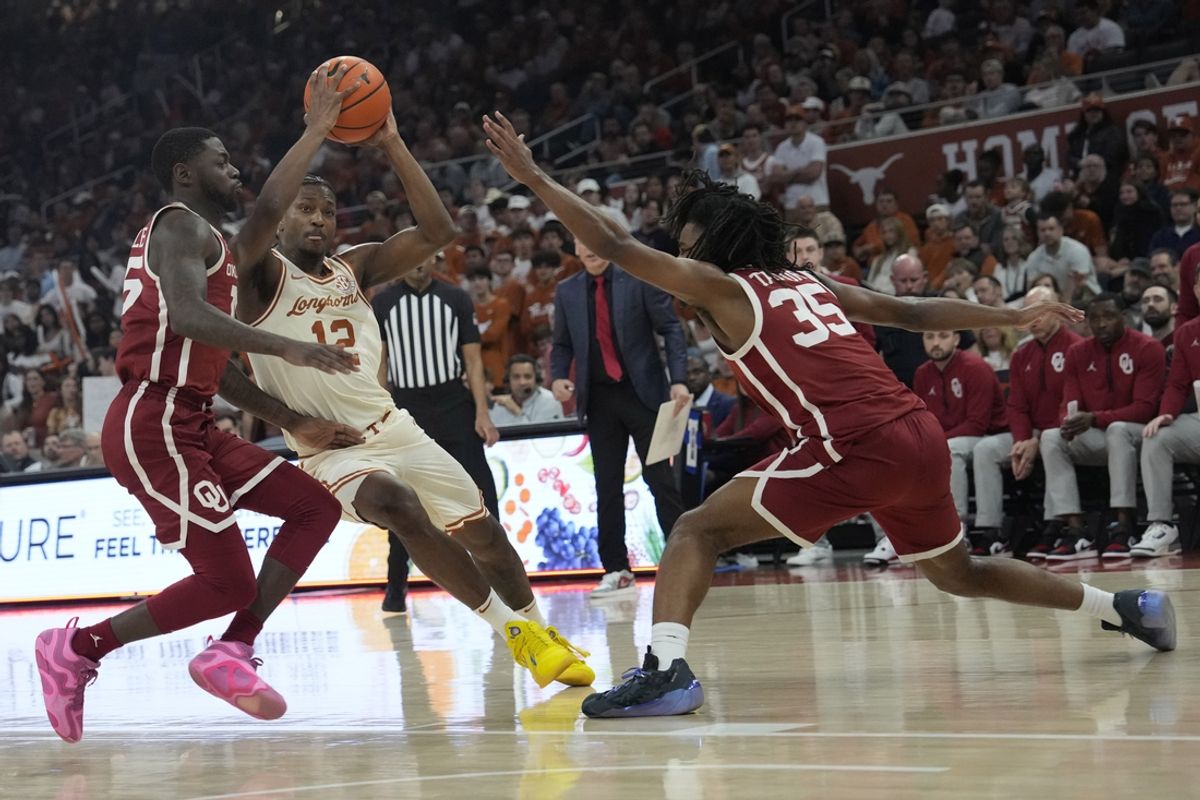 Mar 8, 2025; Austin, Texas, USA; Texas Longhorns guard Tramon Mark (12) drives to the basket between Oklahoma Sooners guard Duke Miles (15) and forward Glenn Taylor Jr. (35) during the first half at Moody Center. Mandatory Credit: Scott Wachter-Imagn Images