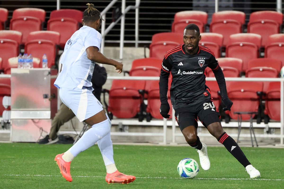 Mar 8, 2025; Washington, District of Columbia, USA; D.C. United forward Christian Benteke (20) tries to slip past Sporting Kansas City defender Dany Rosero (5) during the first half at Audi Field. Mandatory Credit: Daniel Kucin Jr.-Imagn Images