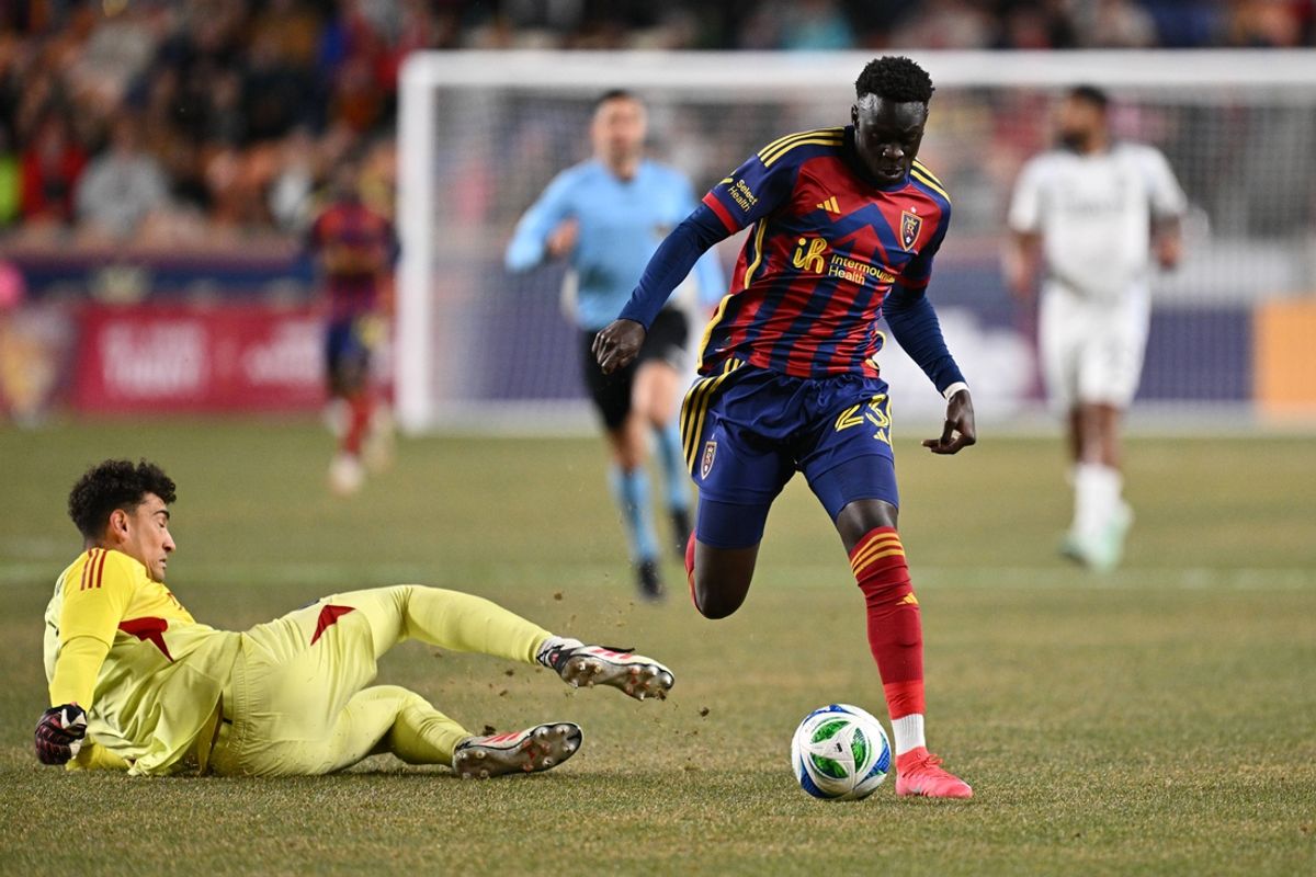 Mar 8, 2025; Sandy, Utah, USA;  Real Salt Lake forward Ariath Piol (23) takes control of the ball just past San Diego FC goalkeeper CJ dos Santos (1) in the first half at America First Field. Mandatory Credit: Jamie Sabau-Imagn Images