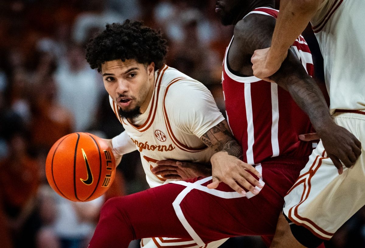 Texas Longhorns guard Jordan Pope (0) pushes past Oklahoma defense in the first half of the Longhorns' game against the Oklahoma Sooners at the Moody Center in Austin, March 8, 2025.