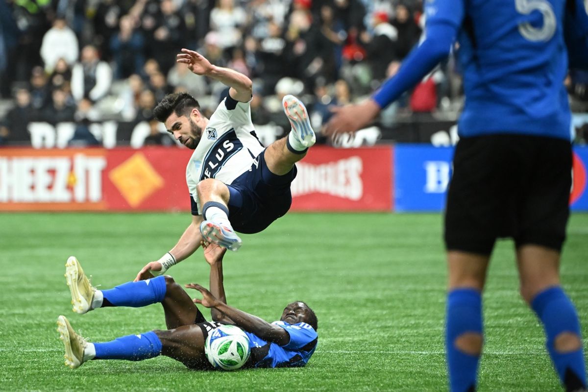 Mar 8, 2025; Vancouver, British Columbia, CAN;  Vancouver Whitecaps FC forward Brian White (24) battles for the ball against CF Montreal midfielder Victor Loturi (22) during the second half at BC Place. Mandatory Credit: Simon Fearn-Imagn Images
