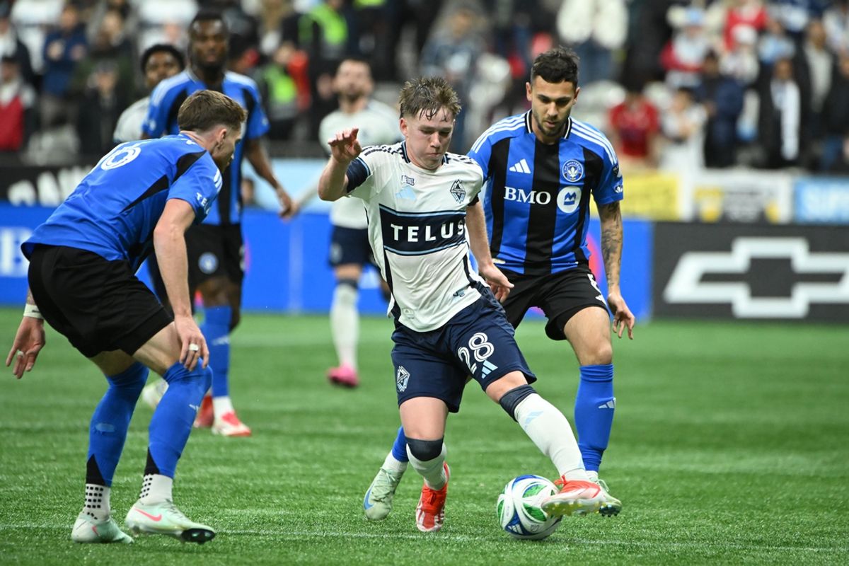 Mar 8, 2025; Vancouver, British Columbia, CAN;  Vancouver Whitecaps FC defender Tate Johnson (28) dribbles the ball against CF Montreal midfielder Dominic Iankov (8) during the second half at BC Place. Mandatory Credit: Simon Fearn-Imagn Images