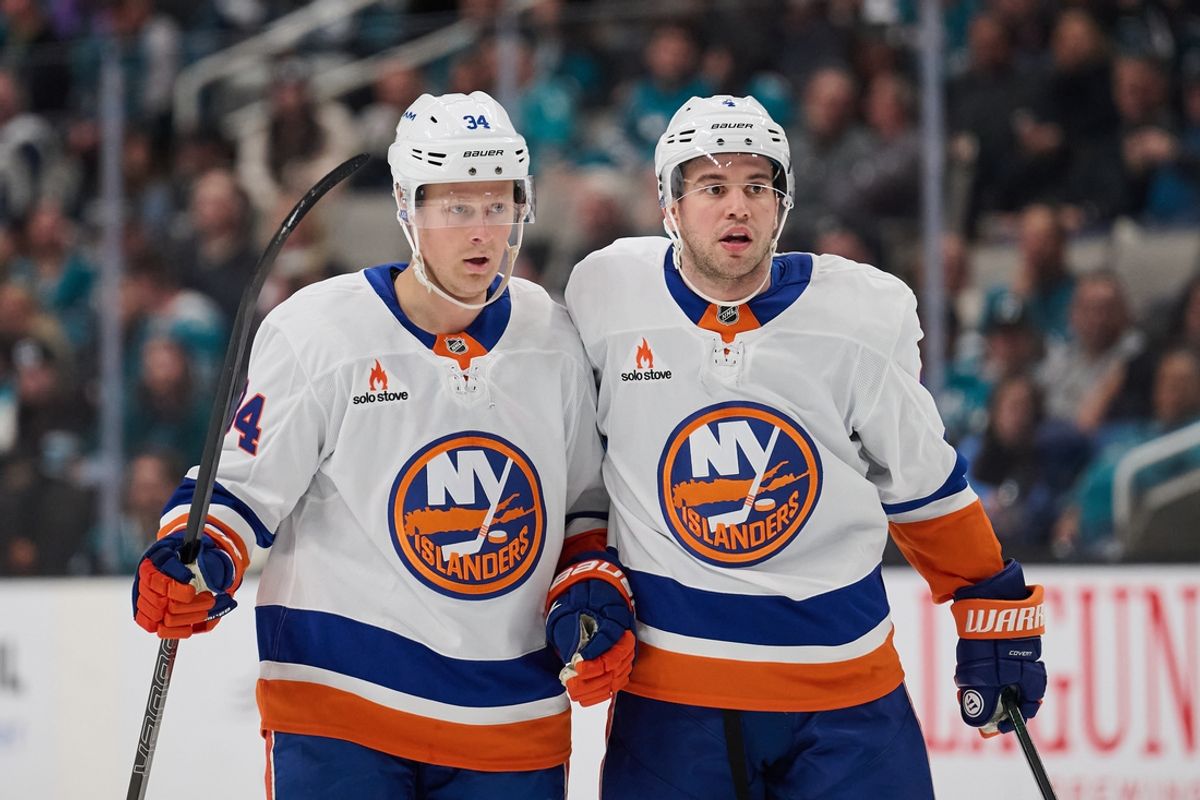 New York Islanders defenseman Adam Boqvist (34) celebrates with defenseman Anthony De Angelo (4) after scoring a goal against the San Jose Sharks during the third period at SAP Center at San Jose.