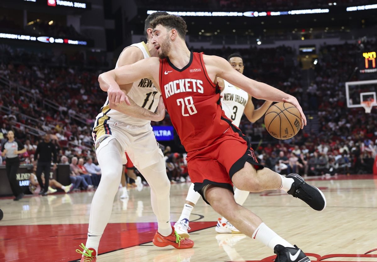 Mar 8, 2025; Houston, Texas, USA;  Houston Rockets center Alperen Sengun (28) controls the ball as New Orleans Pelicans center Karlo Matkovic (17) defends during the game at Toyota Center. Mandatory Credit: Troy Taormina-Imagn Images