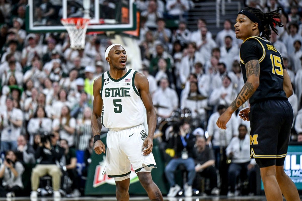 Michigan State's Tre Holloman, left, jaws at Michigan's Rubin Jones after scoring during the second half on Sunday, March 9, 2025, at the Breslin Center in East Lansing.