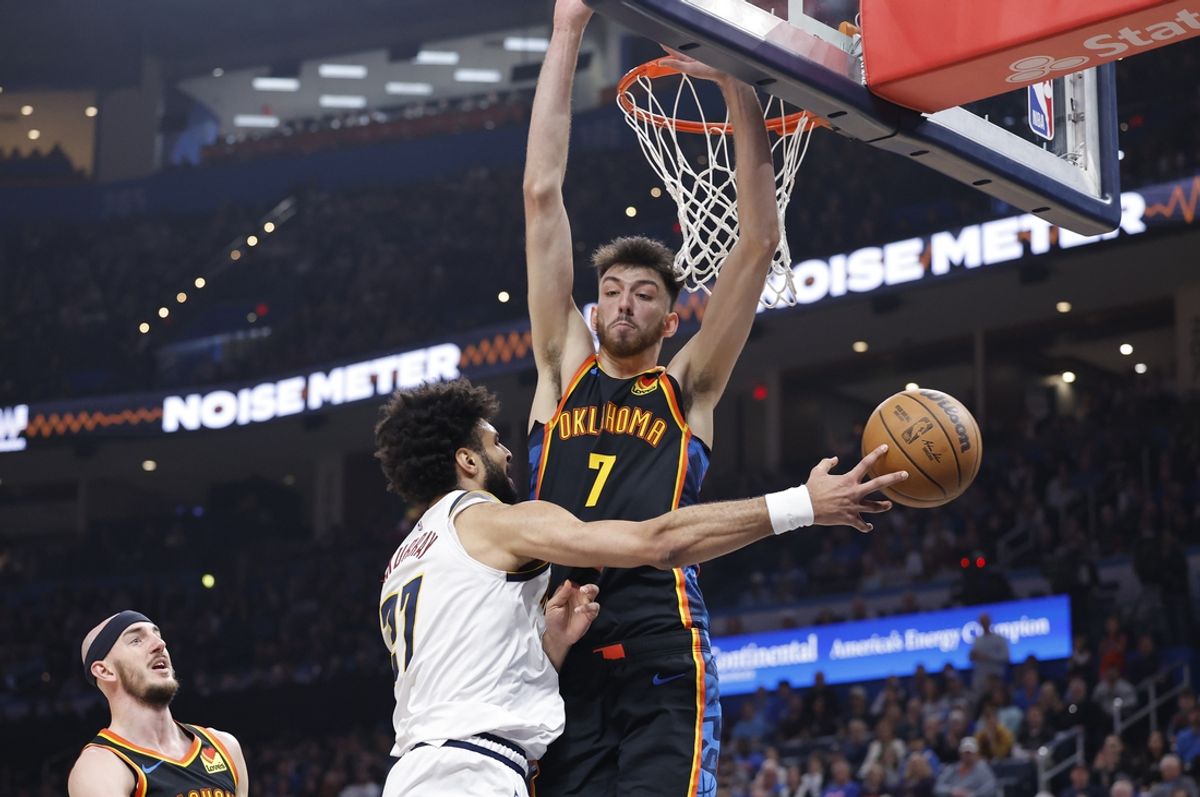 Mar 9, 2025; Oklahoma City, Oklahoma, USA; Denver Nuggets guard Jamal Murray (27) passes around Oklahoma City Thunder forward Chet Holmgren (7) during the second quarter at Paycom Center. Mandatory Credit: Alonzo Adams-Imagn Images