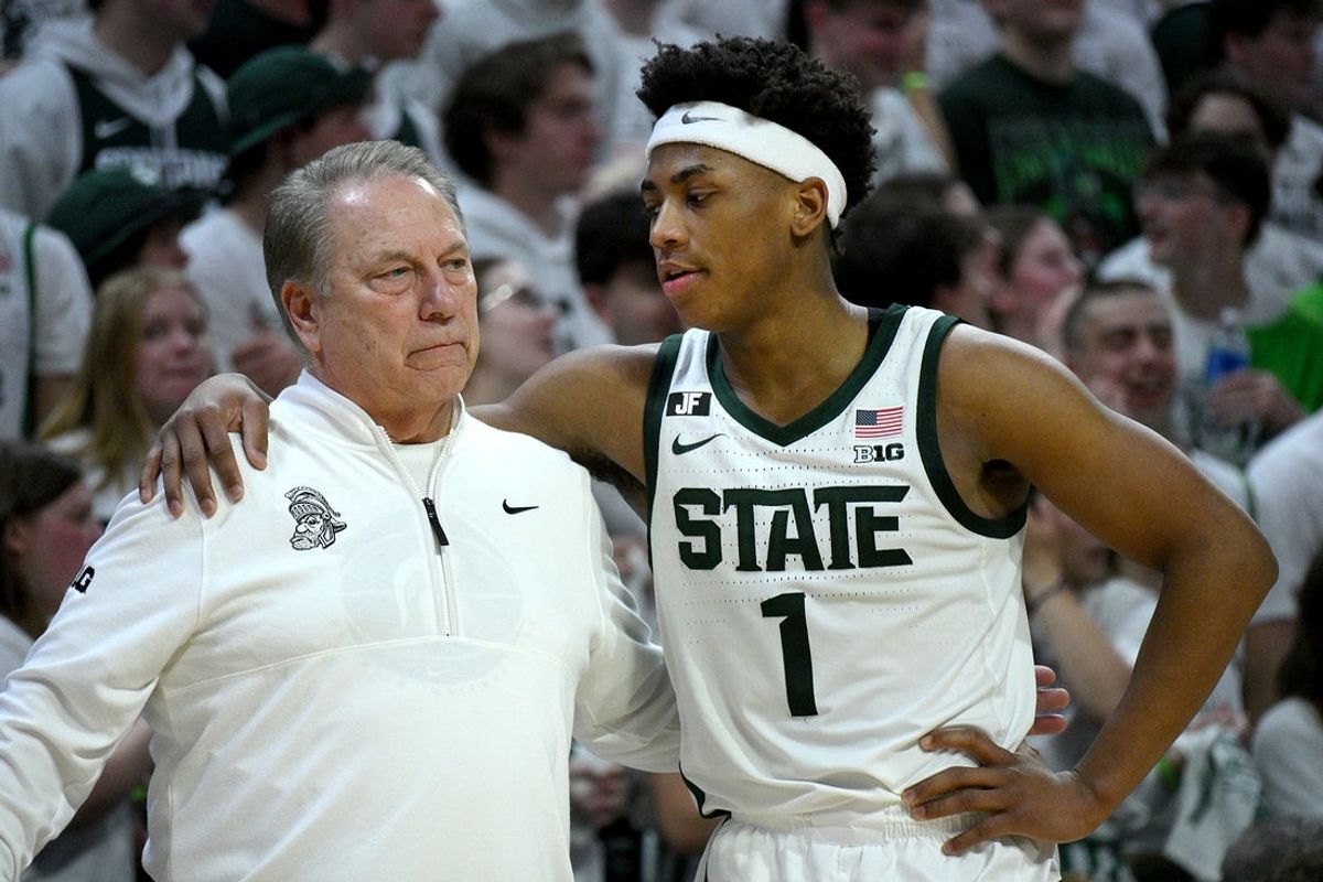 Mar 9, 2025; East Lansing, Michigan, USA;  Michigan State Spartans head coach Tom Izzo huddles with Michigan State Spartans guard Jeremy Fears Jr. (1) during the second half against the Michigan Wolverines at Jack Breslin Student Events Center. Mandatory Credit: Dale Young-Imagn Images