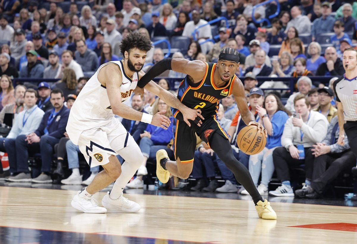 Mar 9, 2025; Oklahoma City, Oklahoma, USA; Oklahoma City Thunder guard Shai Gilgeous-Alexander (2) drives around Denver Nuggets guard Jamal Murray (27) during the second half at Paycom Center. Mandatory Credit: Alonzo Adams-Imagn Images