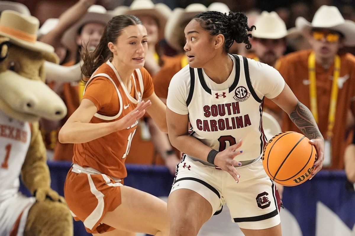 March 9, 2025; Greenville, SC, USA; South Carolina Gamecocks guard Te-Hina Paopao (0) handles the ball against Texas Longhorns guard Shay Holle (10) during the first half at Bon Secours Wellness Arena. Mandatory Credit: Jim Dedmon-Imagn Images