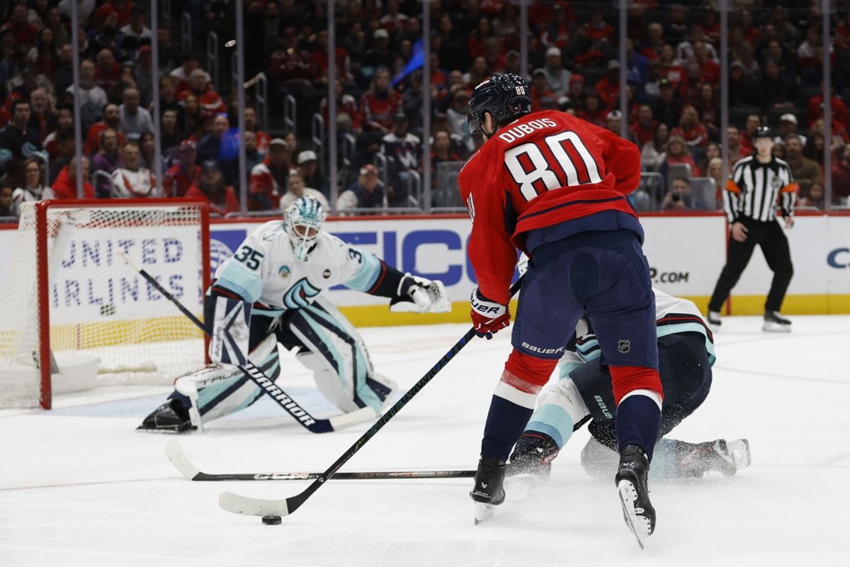 Mar 9, 2025; Washington, District of Columbia, USA; Seattle Kraken goaltender Joey Daccord (35) prepares to make a save on Washington Capitals left wing Pierre-Luc Dubois (80) in the first period at Capital One Arena. Mandatory Credit: Geoff Burke-Imagn Images