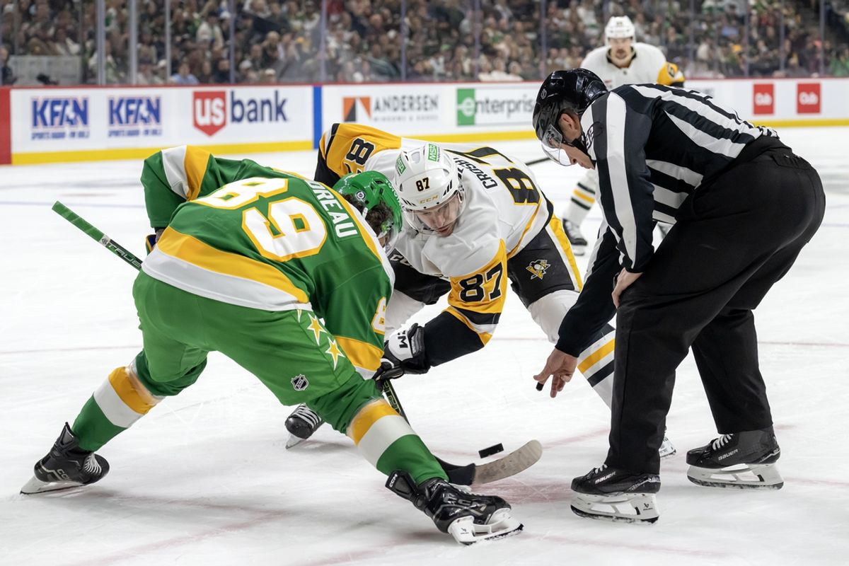 Mar 9, 2025; Saint Paul, Minnesota, USA;  Minnesota Wild forward Frederick Gaudreau (89) and Pittsburgh Penguins forward Sidney Crosby (87) face-off during the first period at Xcel Energy Center. Mandatory Credit: Nick Wosika-Imagn Images