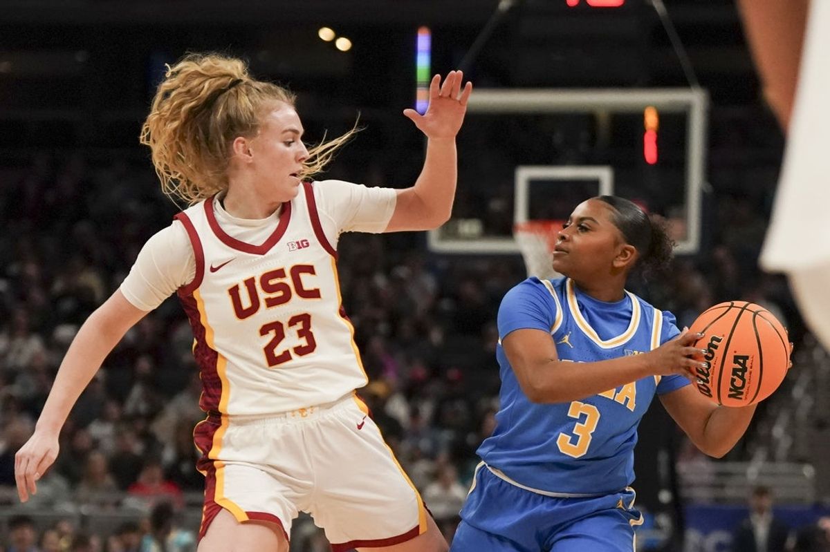 Mar 8, 2025; Indianapolis, IN, USA; UCLA Bruins guard Londynn Jones (3) looks for an open teammate as USC Trojans guard Avery Howell (23) defends during the first period for the Big Ten Conference Championship at Gainbridge Fieldhouse. Mandatory Credit: Stephanie Amador Blondet-Imagn Images