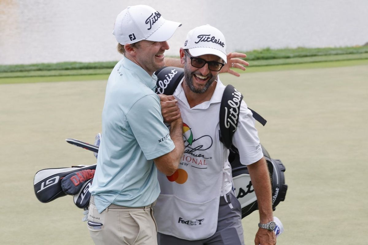 Mar 9, 2025; Orlando, Florida, USA;  Russell Henley (left) hugs his caddie after winning the Arnold Palmer Invitational golf tournament at Bay Hill. Mandatory Credit: Reinhold Matay-Imagn Images
