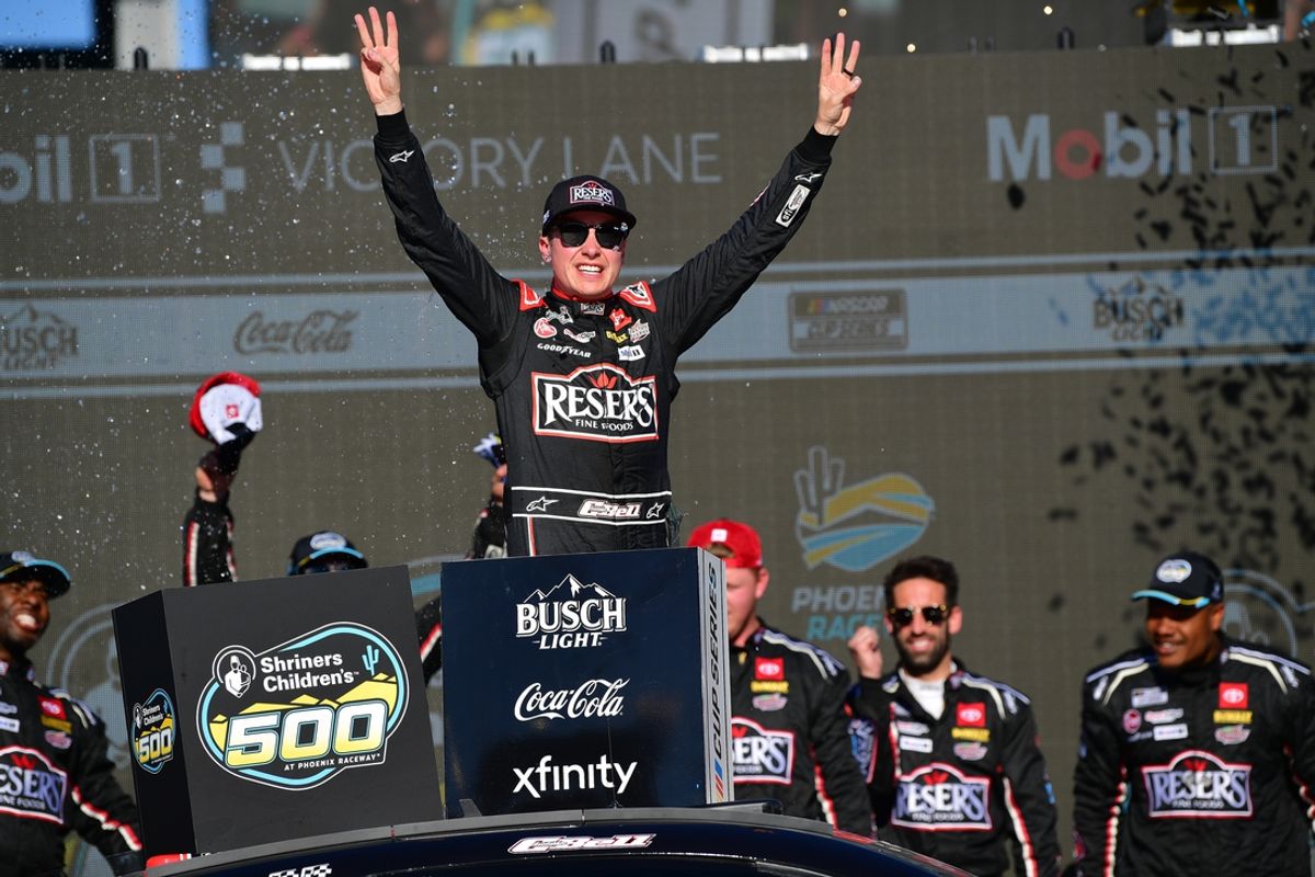 Mar 9, 2025; Avondale, Arizona, USA; NASCAR Cup Series driver Christopher Bell (20) celebrates his victory of the Shriners Children’s 500 at Phoenix Raceway. Mandatory Credit: Gary A. Vasquez-Imagn Images