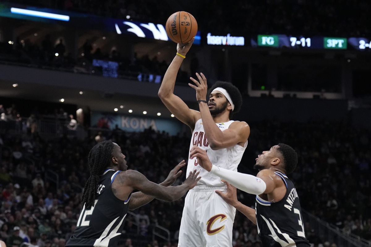 Mar 9, 2025; Milwaukee, Wisconsin, USA; Cleveland Cavaliers center Jarrett Allen (31) puts up a shot against Milwaukee Bucks forward Taurean Prince (12) and Milwaukee Bucks forward Giannis Antetokounmpo (34) in the first half at Fiserv Forum. Mandatory Credit: Michael McLoone-Imagn Images
