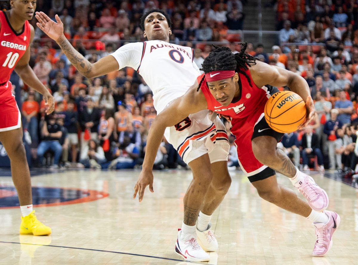 Georgia Bulldogs guard Silas Demary Jr. (5) drives the ball on Auburn Tigers guard Tahaad Pettiford (0) as Auburn Tigers take on Georgia Bulldogs at Neville Arena in Auburn, Ala., on Saturday, Feb. 22, 2025. Auburn Tigers lead Georgia Bulldogs 29-24 at halftime.