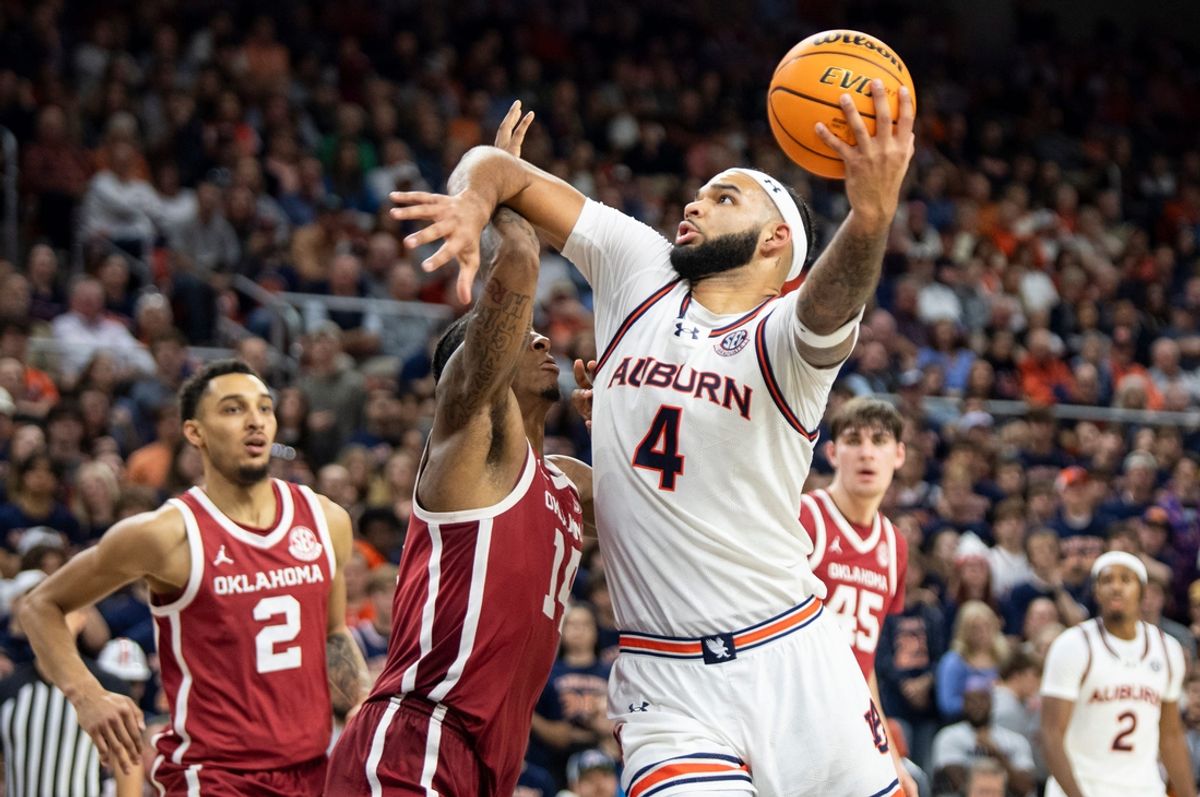 Auburn Tigers forward Johni Broome (4) makes a post move on Oklahoma Sooners forward Jalon Moore (14) as Auburn Tigers take on Oklahoma Sooners at Neville Arena in Auburn, Ala., on Tuesday, Feb. 4, 2025. Auburn Tigers defeated Oklahoma Sooners 98-70.