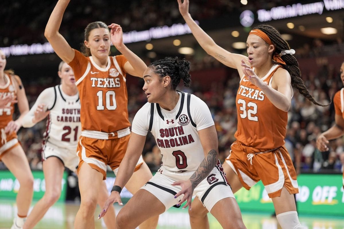 Mar 9, 2025; Greenville, SC, USA;South Carolina Gamecocks guard Te-Hina Paopao (0) moves on the court defended by Texas Longhorns guard Shay Holle (10) and guard Ndjakalenga Mwenentanda (32) during the second half at Bon Secours Wellness Arena. Mandatory Credit: Jim Dedmon-Imagn Images