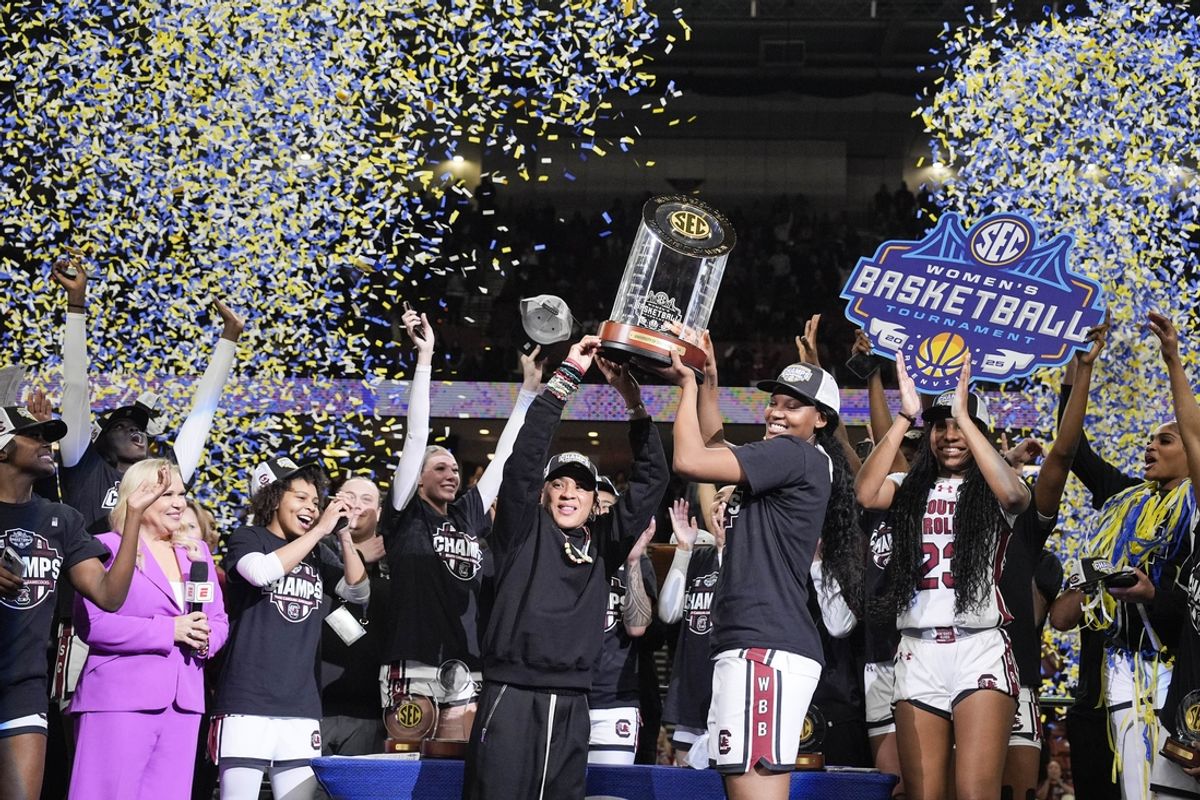 Mar 9, 2025; Greenville, SC, USA;  South Carolina Gamecocks head coach Dawn Staley and forward Sania Feagin (20) hoist the SEC Championship Trophy after her teams win over Texas during the SEC Womenís Tournament at Bon Secours Wellness Arena. Mandatory Credit: Jim Dedmon-Imagn Images