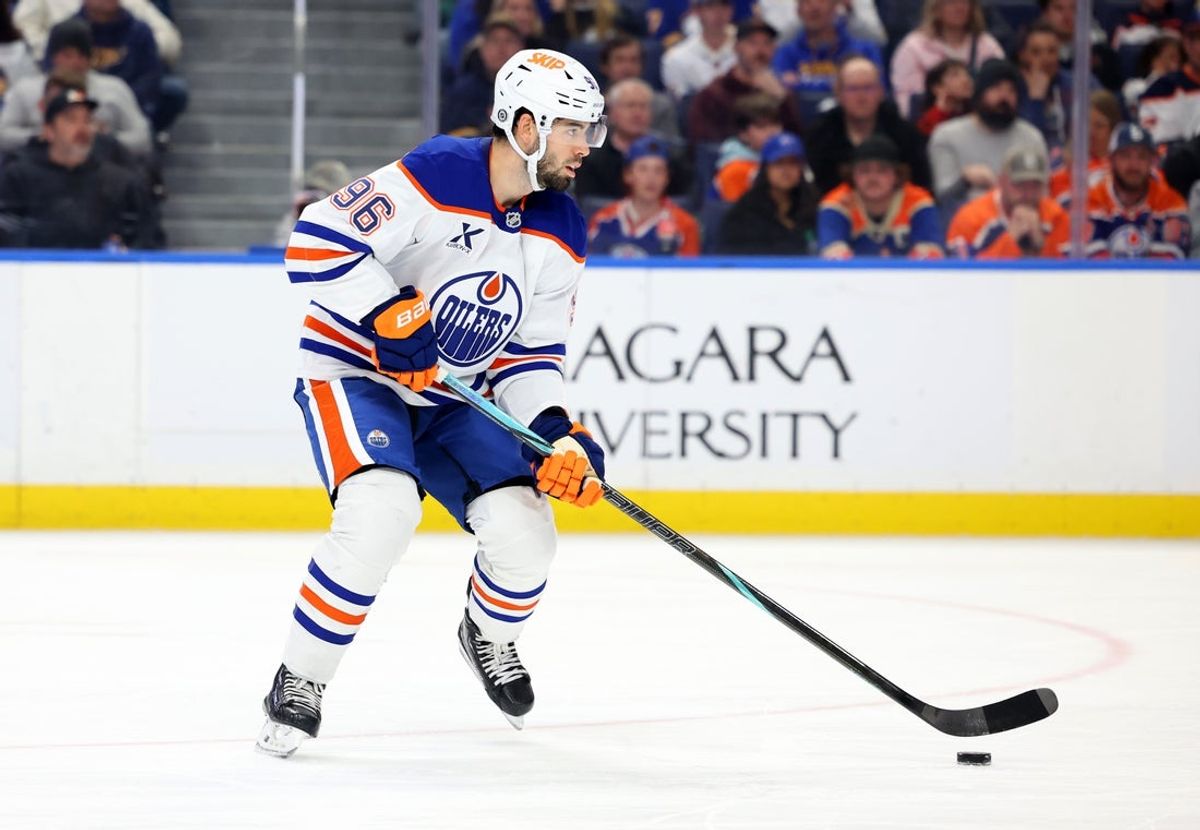 Mar 10, 2025; Buffalo, New York, USA;  Edmonton Oilers defenseman Jake Walman (96) skates up ice with the puck during the second period against the Buffalo Sabres at KeyBank Center. Mandatory Credit: Timothy T. Ludwig-Imagn Images