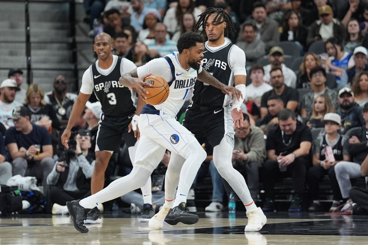 Mar 10, 2025; San Antonio, Texas, USA;  Dallas Mavericks forward Naji Marshall (13) dribbles against San Antonio Spurs guard Stephon Castle (5) in the first half at Frost Bank Center. Mandatory Credit: Daniel Dunn-Imagn Images