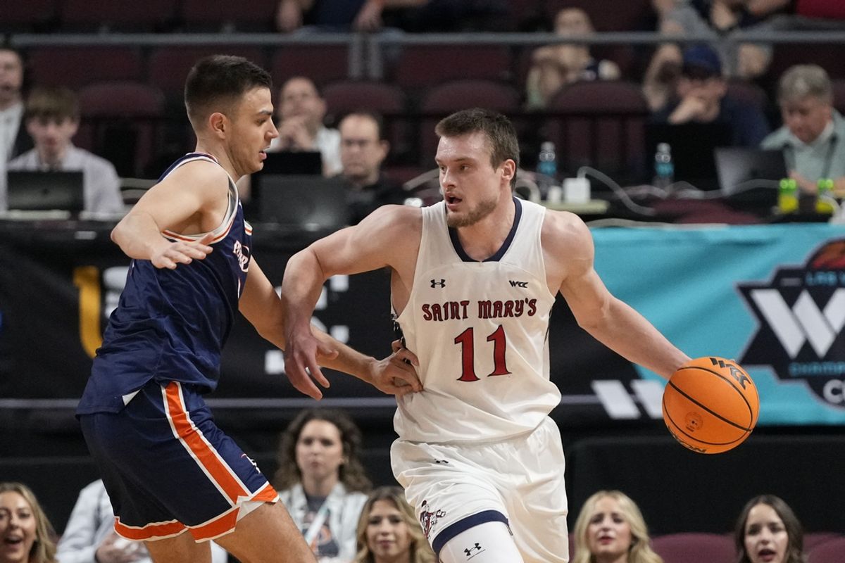March 10, 2025; Las Vegas, NV, USA; St. Mary's Gaels center Mitchell Saxen (11) dribbles the basketball against Pepperdine Waves forward Stefan Todorovic (7) during the first half in the semifinal of the West Coast Conference tournament at Orleans Arena. Mandatory Credit: Kyle Terada-Imagn Images