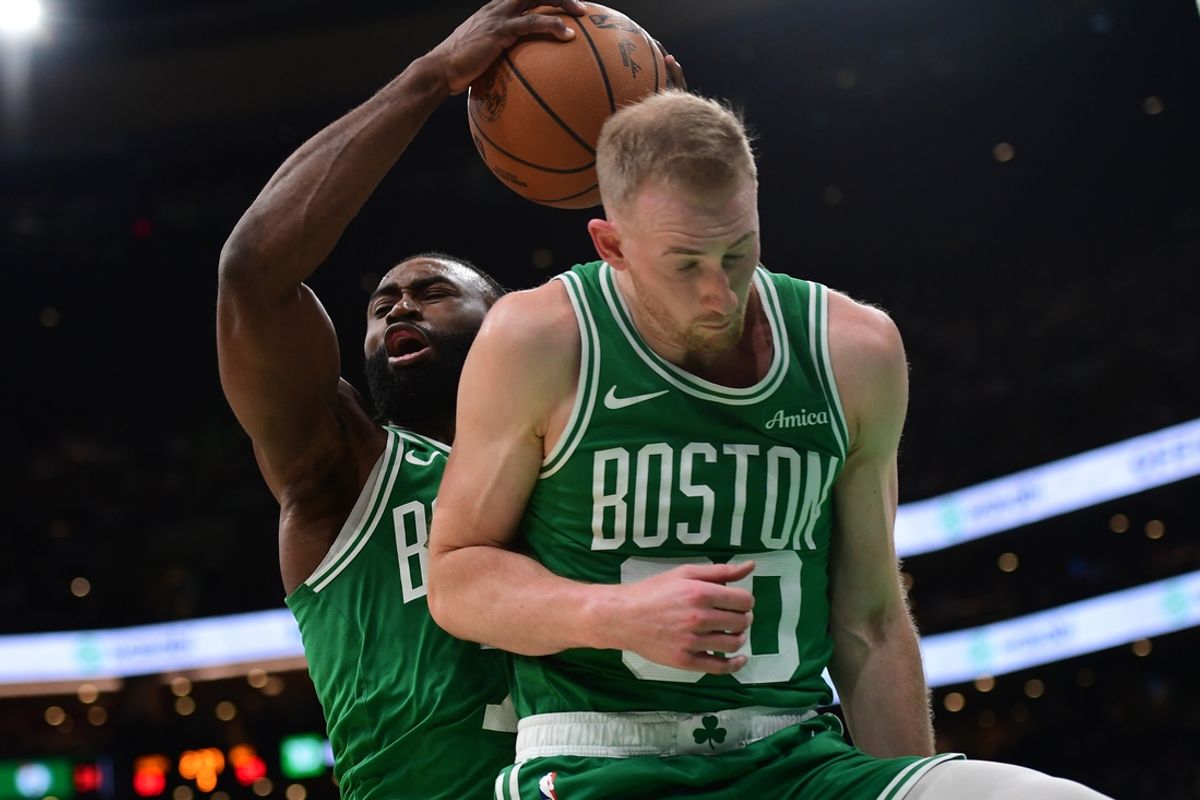 Mar 10, 2025; Boston, Massachusetts, USA;  Boston Celtics guard Jaylen Brown (7) grabs a rebound in front of forward Sam Hauser (30) during the second half at TD Garden. Mandatory Credit: Bob DeChiara-Imagn Images