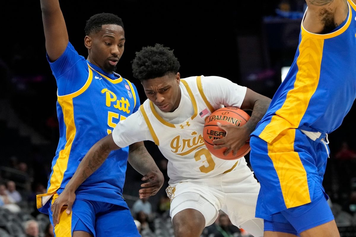 Mar 11, 2025; Charlotte, NC, USA; Notre Dame Fighting Irish guard Markus Burton (3) with the ball as Pittsburgh Panthers forward Zack Austin (55) and forward Cameron Corhen (2) defend in the first half at Spectrum Center. Mandatory Credit: Bob Donnan-Imagn Images