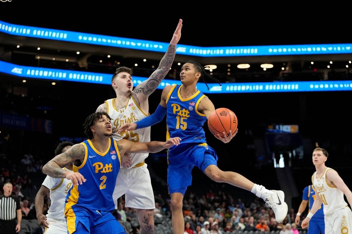 Mar 11, 2025; Charlotte, NC, USA; Pittsburgh Panthers guard Jaland Lowe (15) shoots as Notre Dame Fighting Irish forward Nikita Konstantynovskyi (25) defends in the second half at Spectrum Center. Mandatory Credit: Bob Donnan-Imagn Images