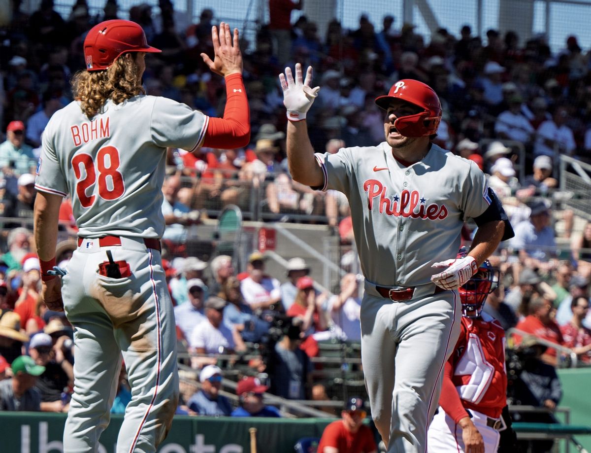 Mar 11, 2025; Fort Myers, Florida, USA; Philadelphia Phillies player Buddy Kennedy (3) crosses home plate and gets a high fives form Alec Bohm (28) after a home run against the Boston Red Sox at JetBlue Park at Fenway South. Mandatory Credit: Chris Tilley-Imagn Images