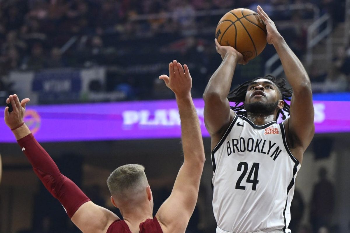 Mar 11, 2025; Cleveland, Ohio, USA; Brooklyn Nets guard Cam Thomas (24) shoots beside Cleveland Cavaliers guard Sam Merrill (5) in the first quarter at Rocket Arena. Mandatory Credit: David Richard-Imagn Images