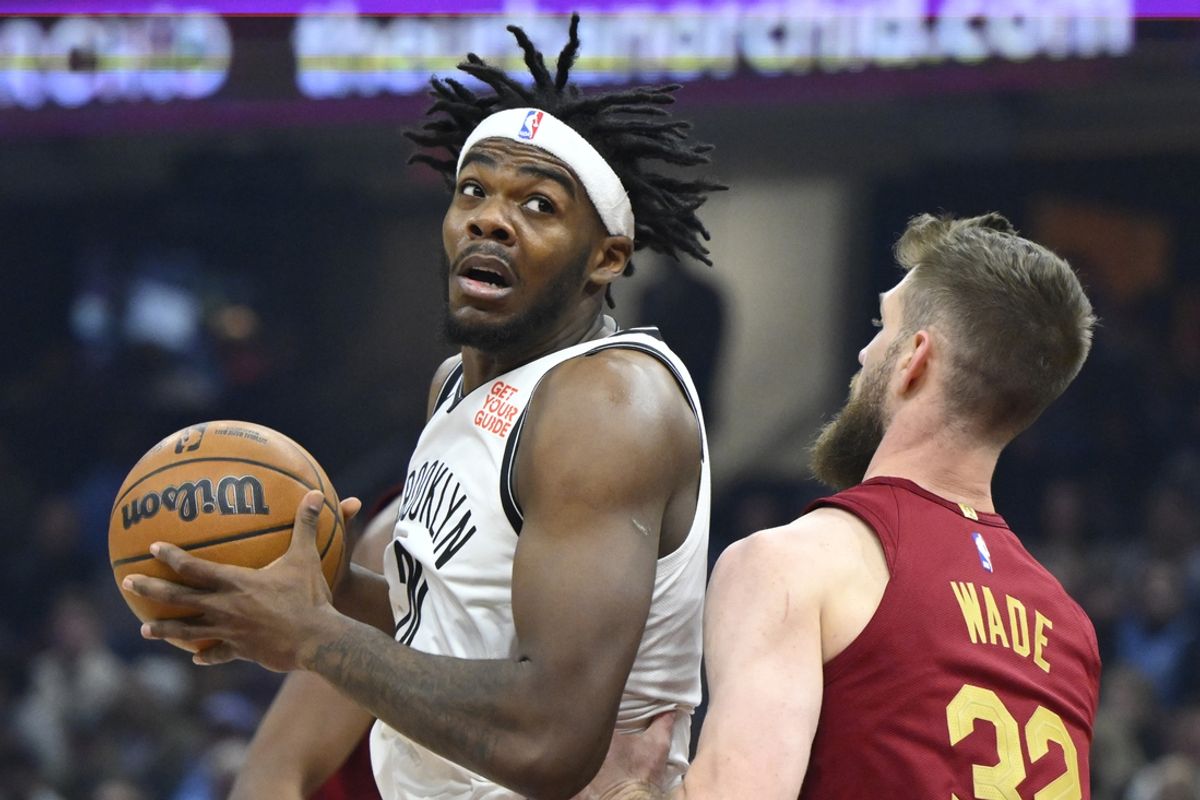 Mar 11, 2025; Cleveland, Ohio, USA; Brooklyn Nets center Day'Ron Sharpe (20) turns to the basket beside Cleveland Cavaliers forward Dean Wade (32) in the first quarter at Rocket Arena. Mandatory Credit: David Richard-Imagn Images