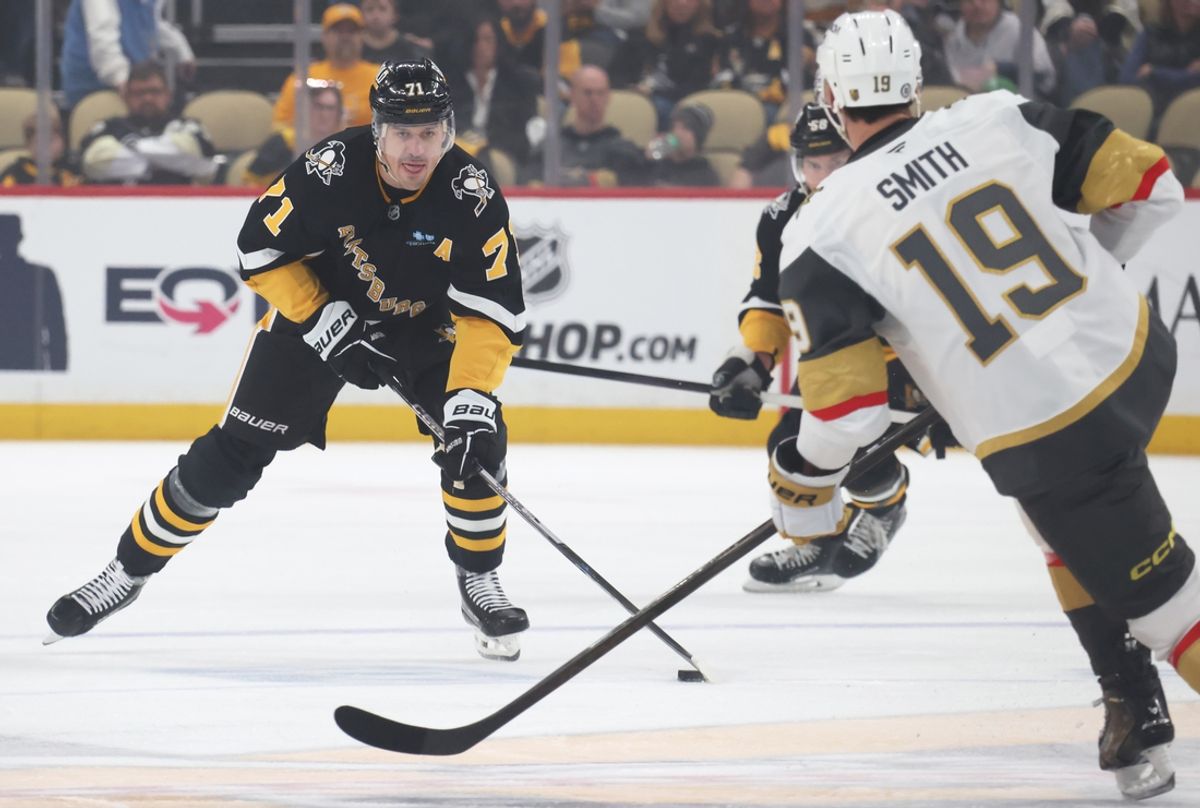 Mar 11, 2025; Pittsburgh, Pennsylvania, USA;  Pittsburgh Penguins center Evgeni Malkin (71) skates with the puck as Vegas Golden Knights right wing Reilly Smith (19) defends during the first period at PPG Paints Arena. Mandatory Credit: Charles LeClaire-Imagn Images