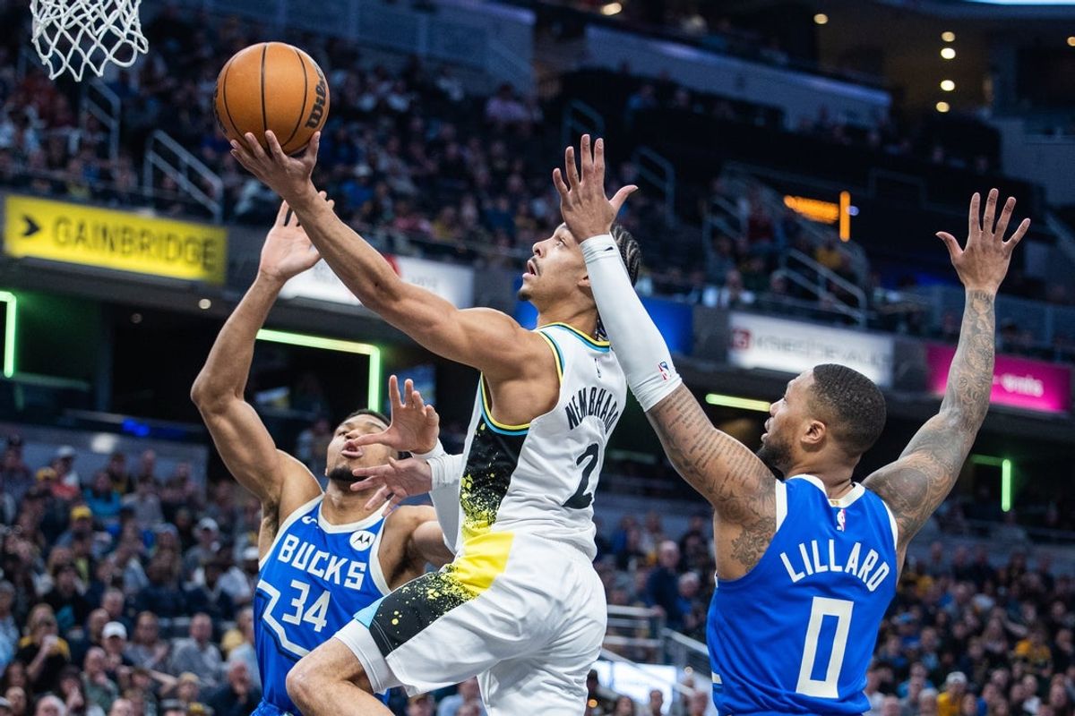 Mar 11, 2025; Indianapolis, Indiana, USA; Indiana Pacers guard Andrew Nembhard (2)shoots the ball while Milwaukee Bucks forward Giannis Antetokounmpo (34) and  guard Damian Lillard (0) defend in the first half  at Gainbridge Fieldhouse. Mandatory Credit: Trevor Ruszkowski-Imagn Images