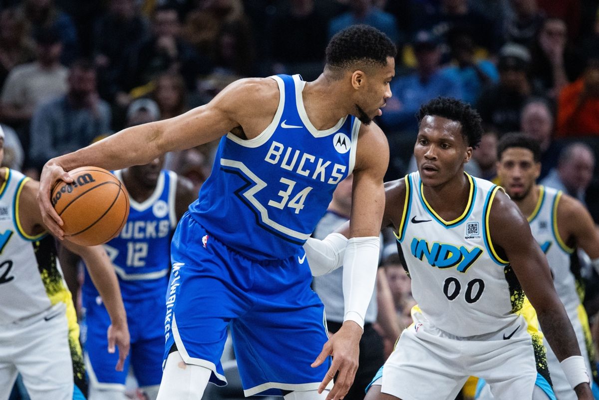 Mar 11, 2025; Indianapolis, Indiana, USA; Milwaukee Bucks forward Giannis Antetokounmpo (34) dribbles the ball while Indiana Pacers guard Bennedict Mathurin (00) defends in the first half  at Gainbridge Fieldhouse. Mandatory Credit: Trevor Ruszkowski-Imagn Images