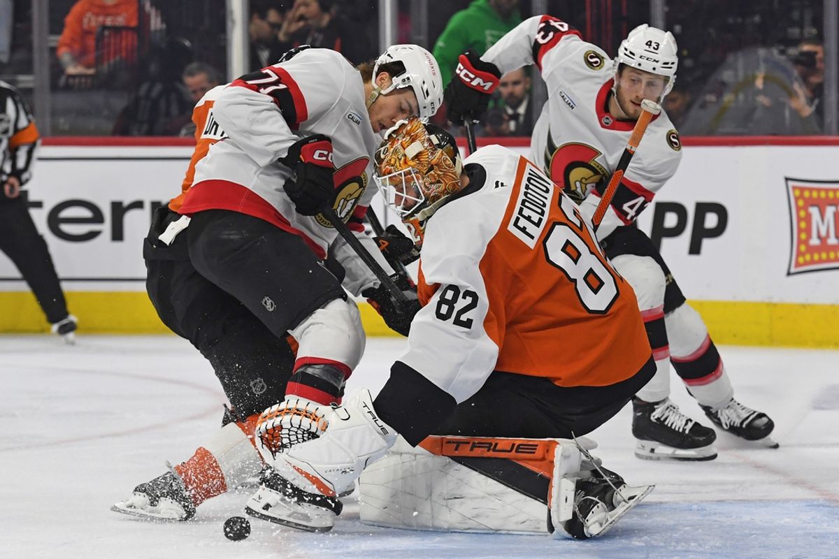 Mar 11, 2025; Philadelphia, Pennsylvania, USA; Philadelphia Flyers goaltender Ivan Fedotov (82) makes a save against Ottawa Senators center Ridly Greig (71) during the second period at Wells Fargo Center. Mandatory Credit: Eric Hartline-Imagn Images