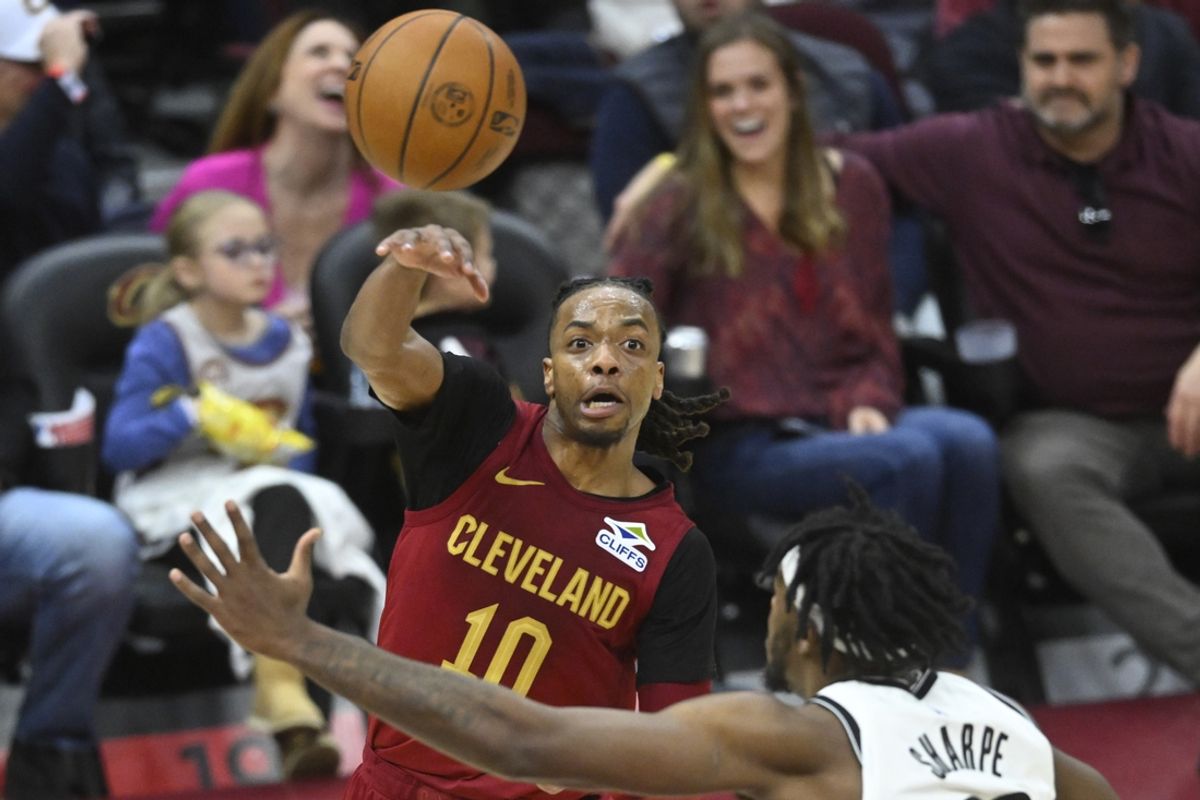 Mar 11, 2025; Cleveland, Ohio, USA; Cleveland Cavaliers guard Darius Garland (10) throws a pass beside Brooklyn Nets center Day'Ron Sharpe (20) in the third quarter at Rocket Arena. Mandatory Credit: David Richard-Imagn Images