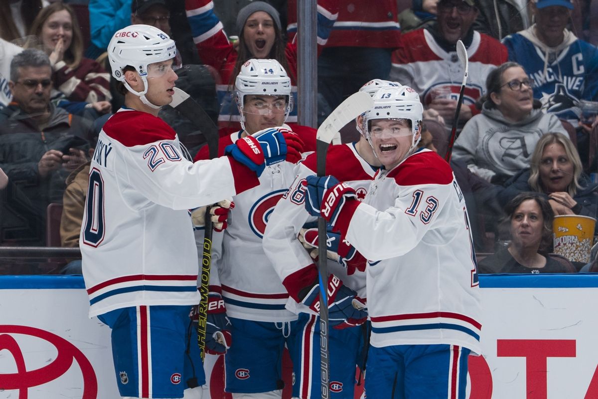 Mar 11, 2025; Vancouver, British Columbia, CAN; Montreal Canadiens forward Juraj Slafkovský (20) and forward Nick Suzuki (14) and defenseman Lane Hutson (48) and forward Cole Caufield (13) celebrate Slafkovský’s goal against the Vancouver Canucks  in the first period at Rogers Arena. Mandatory Credit: Bob Frid-Imagn Images