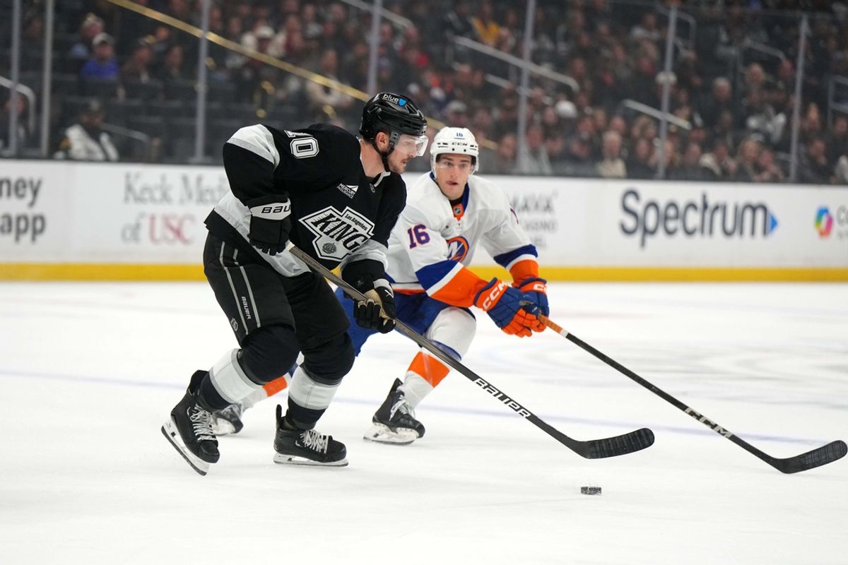 Mar 11, 2025; Los Angeles, California, USA; LA Kings left wing Tanner Jeannot (10) skates against New York Islanders center Marc Gatcomb (16) in the first period at the Crypto.com Arena. Mandatory Credit: Kirby Lee-Imagn Images
