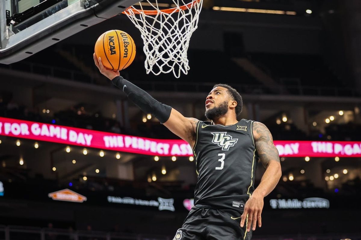 Mar 11, 2025; Kansas City, MO, USA; UCF Knights guard Darius Johnson (3) shoots the ball during the second half against the Utah Utes at T-Mobile Center. Mandatory Credit: William Purnell-Imagn Images
