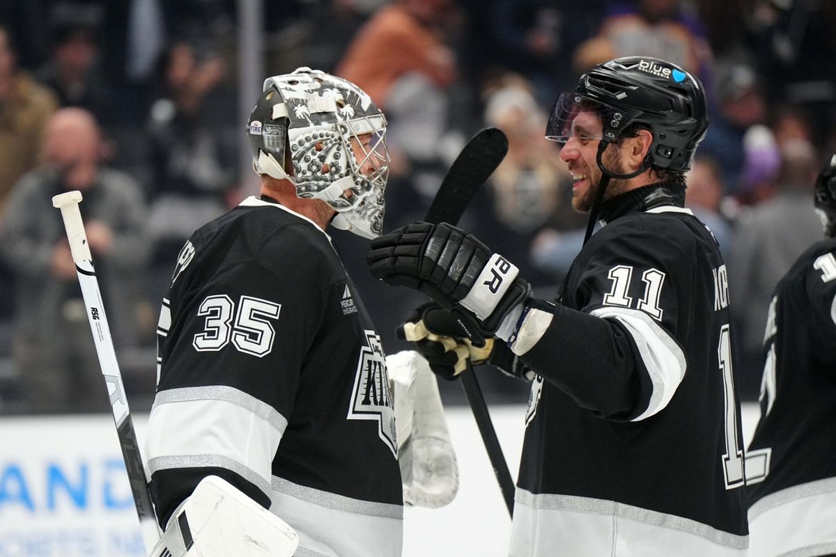 LA Kings goaltender Darcy Kuemper (35) and center Anze Kopitar (11) celebrate at the end of the game against the New York Islanders at the Crypto.com Arena.