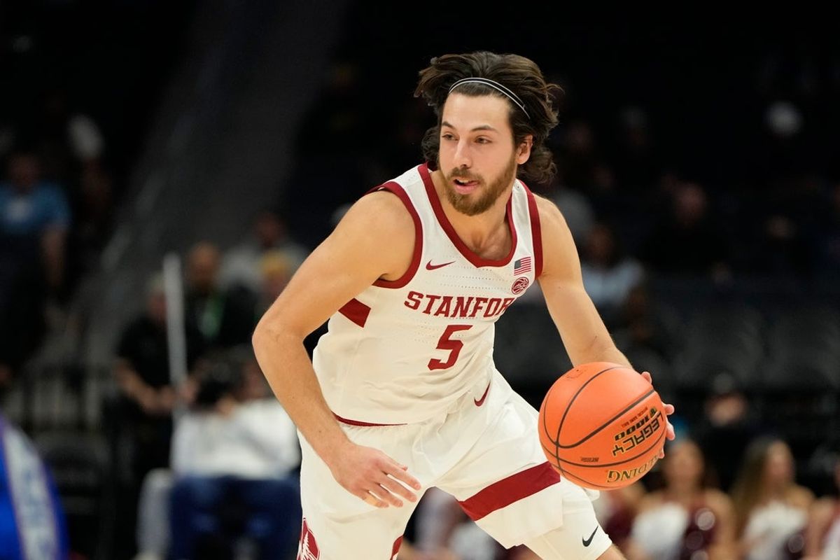 Mar 12, 2025; Charlotte, NC, USA; Stanford Cardinal forward Chisom Okpara (10) shoots as California Golden Bears forward Spencer Mahoney (7) defends in the first half at Spectrum Center. Mandatory Credit: Bob Donnan-Imagn Images