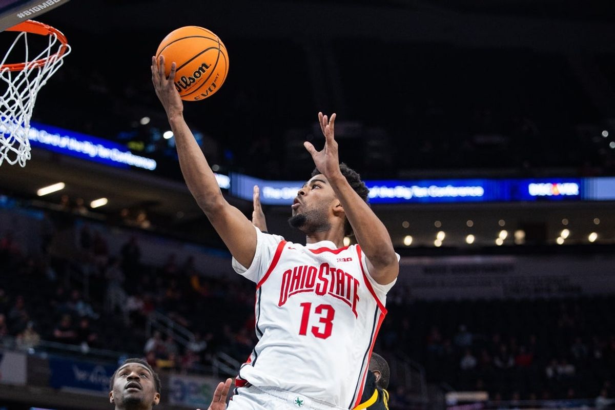 Mar 12, 2025; Indianapolis, IN, USA; Ohio State Buckeyes forward Sean Stewart (13) shoots the ball while Iowa Hawkeyes forward Ladji Dembele (13) defends in the second half  at Gainbridge Fieldhouse. Mandatory Credit: Trevor Ruszkowski-Imagn Images