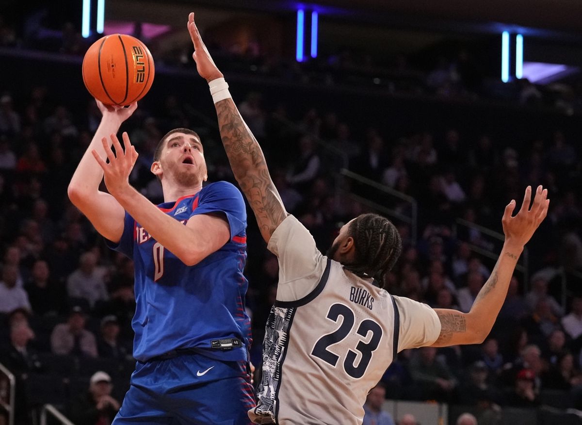 Mar 12, 2025; New York, NY, USA; DePaul Blue Demons forward Troy D'Amico (0) shoots over Georgetown Hoyas forward Jordan Burks (23) during the second half at Madison Square Garden. Mandatory Credit: Robert Deutsch-Imagn Images