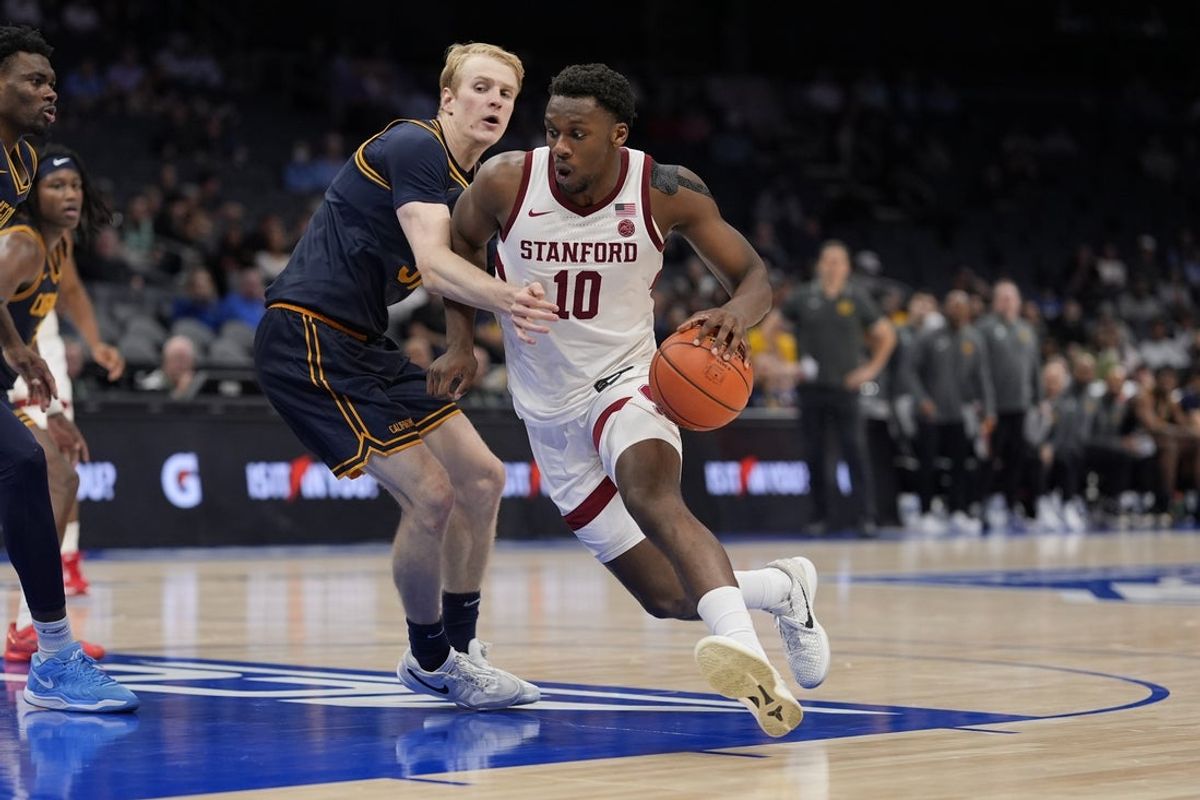 Mar 12, 2025; Charlotte, NC, USA; Stanford Cardinal forward Chisom Okpara (10) drives to the basket against California Golden Bears forward Rytis Petraitis (31) during the second half at Spectrum Center. Mandatory Credit: Jim Dedmon-Imagn Images